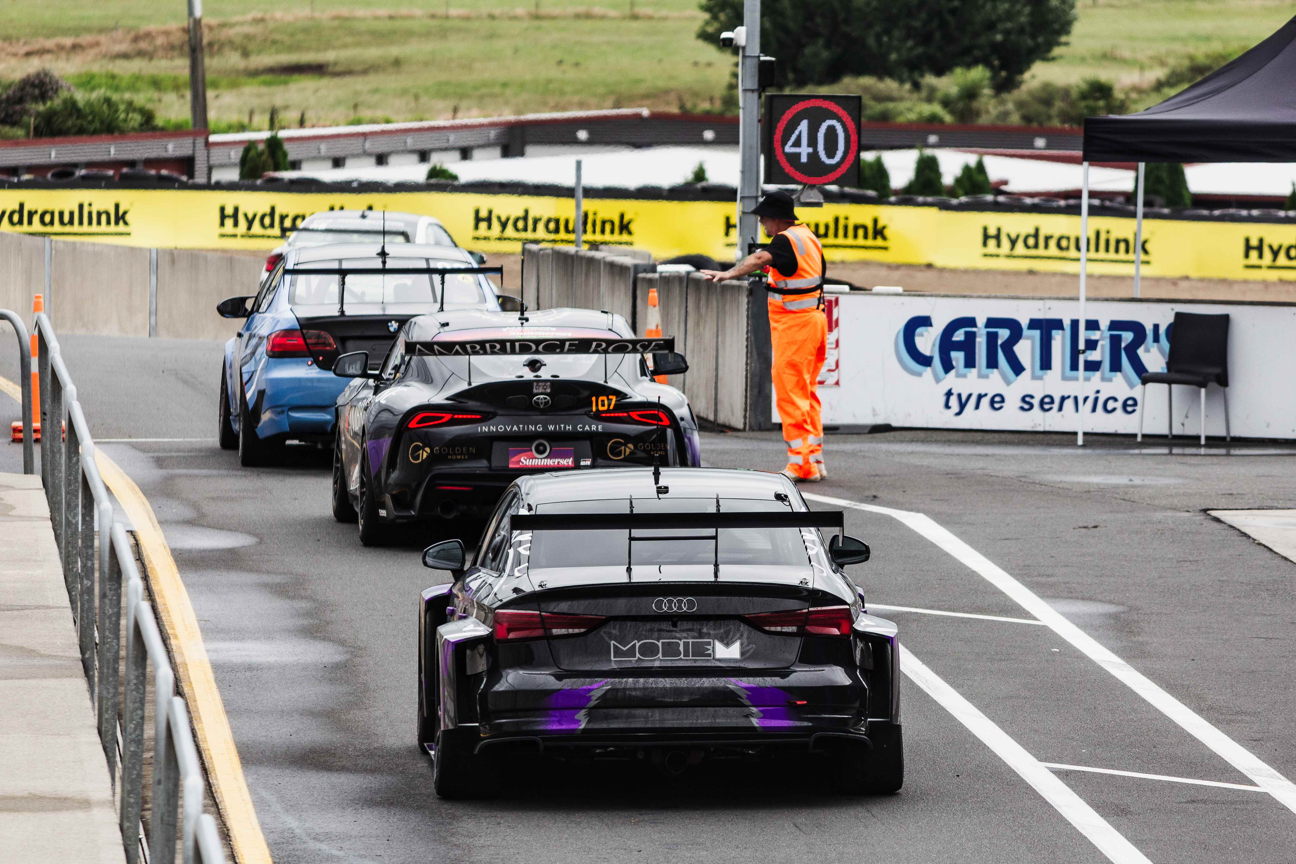 Cars queued in the pit lane