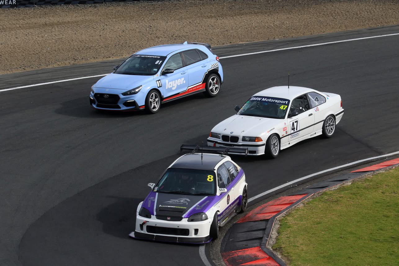 Pack of cars racing through a corner